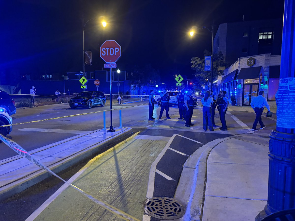 According to witnesses, five people are involved in a shooting on the corner, and an officer is injured but stable