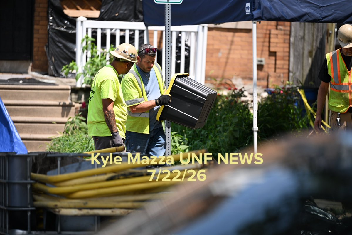 Law enforcement officers and utility crews are seen excavating and collecting items into containers at the home of Eugene Horsch on the 400 block of West Chew Avenue in the Olney neighborhood in Philadelphia, Pennsylvania