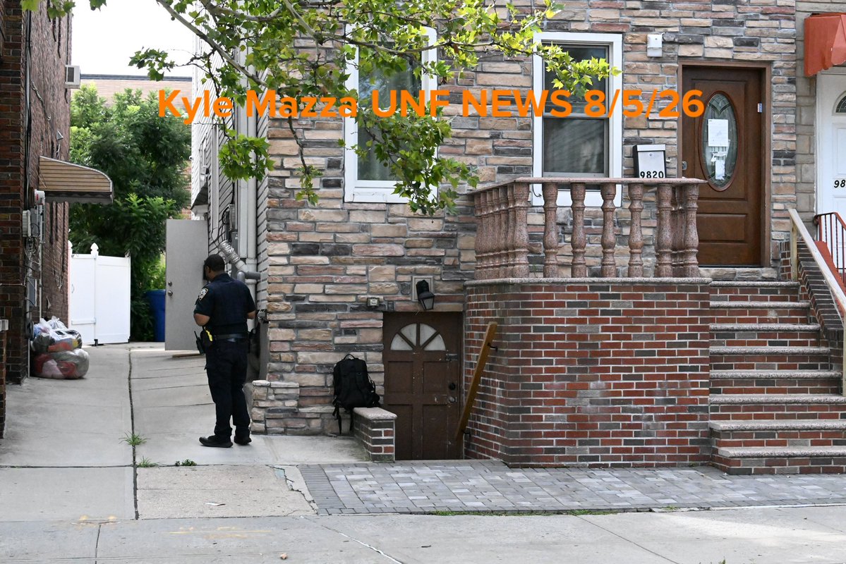 NYPD officers work the scene where a 6-month-old boy died inside of a home in the vicinity of Flatlands Avenue and East 99th Street in Brooklyn, New York