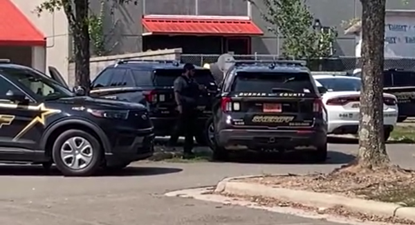 Two high school students in Durham are facing charges after a gun and ammunition were found on campus Tuesday morning, the sheriff's office said.