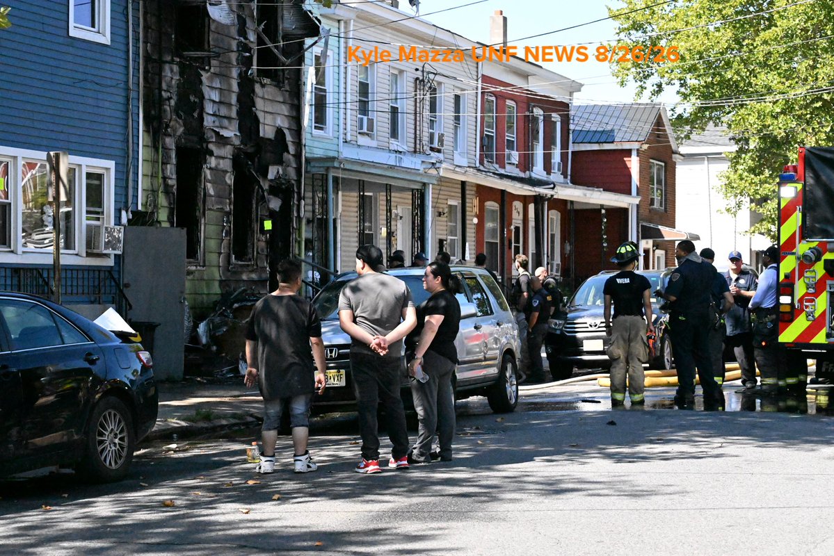 Trenton Fire Department personnel and investigators work the scene where two children died after a three-alarm house fire on the 300 block of Hewitt Street in Trenton, New Jersey