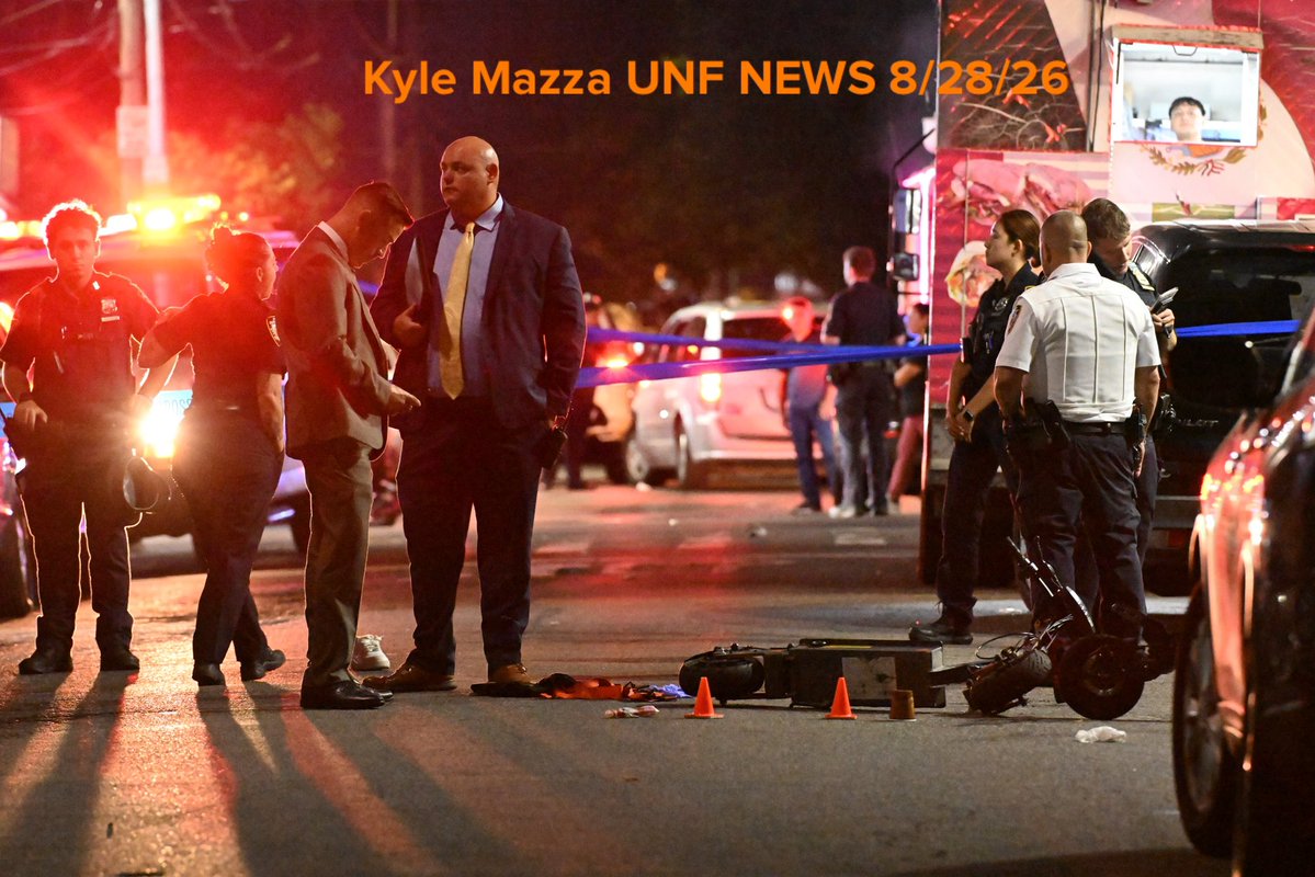 NYPD officers work the scene where a 13-year-old boy and an 18-year-old man were shot in the area of 39th Avenue and 104th Street in Queens, New York, United States on Friday